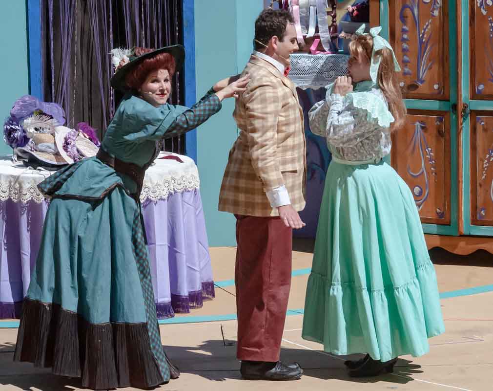 Photo by Robin Jackson LOVE STORY (From left) Dolly Gallagher Levi (Dyan McBride) plays matchmaker for Barnaby Tucker (Zachary Frangos) and Minnie Fay (Julia Ludwig) in ‘Hello, Dolly!’