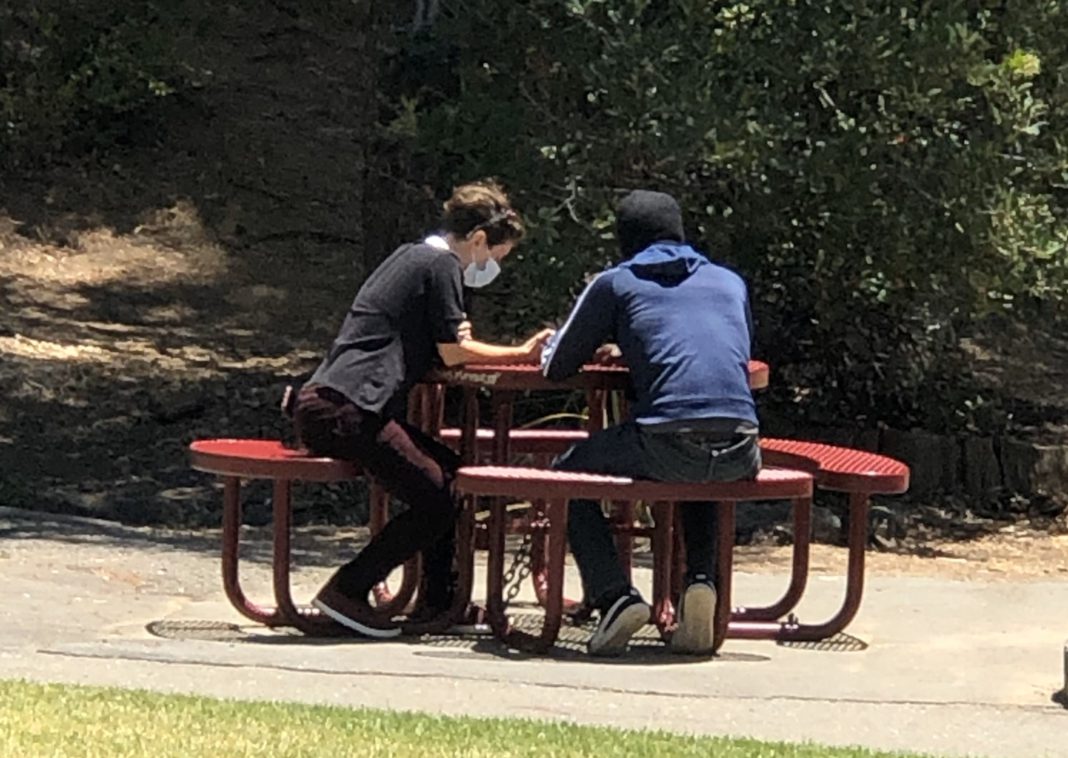 A chaplain from The Street Chaplaincy in Marin offers spiritual support to a homeless person in San Rafael.